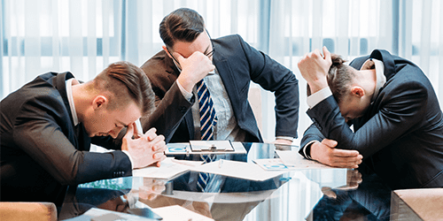 Image of frustrated business men. Learn more about cloud migration challenges and how to deal with them.
