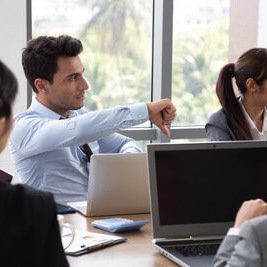 Man pointing thumbs down in the office