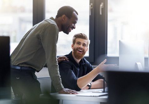 Two happy men working together